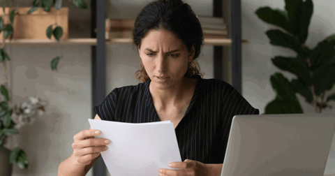 woman looking upset at letter